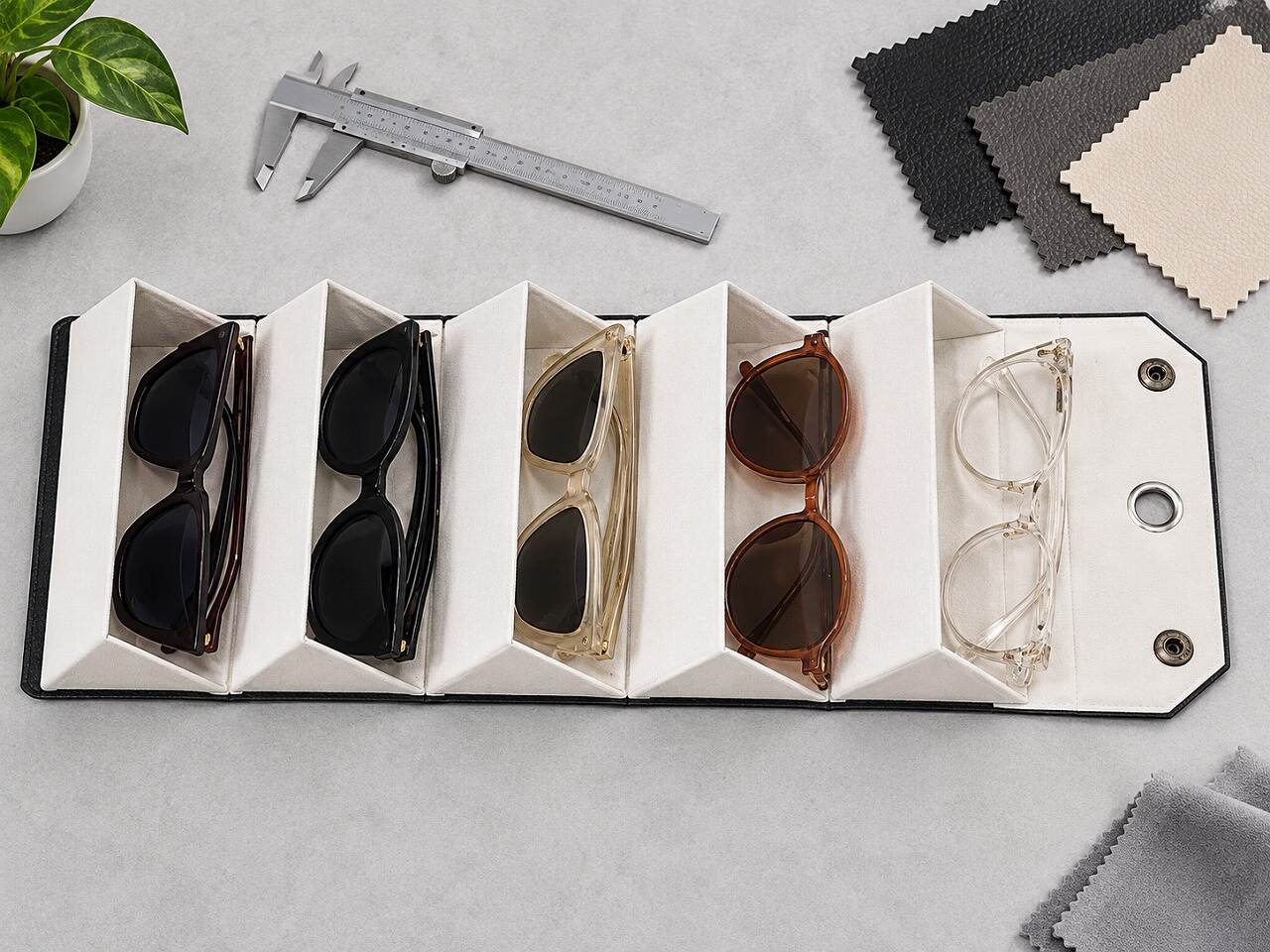 Overhead view of a custom PU leather sunglasses organizer with five separate eyewear compartments Overhead view of a custom PU leather sunglasses organizer with five separate eyewear compartments